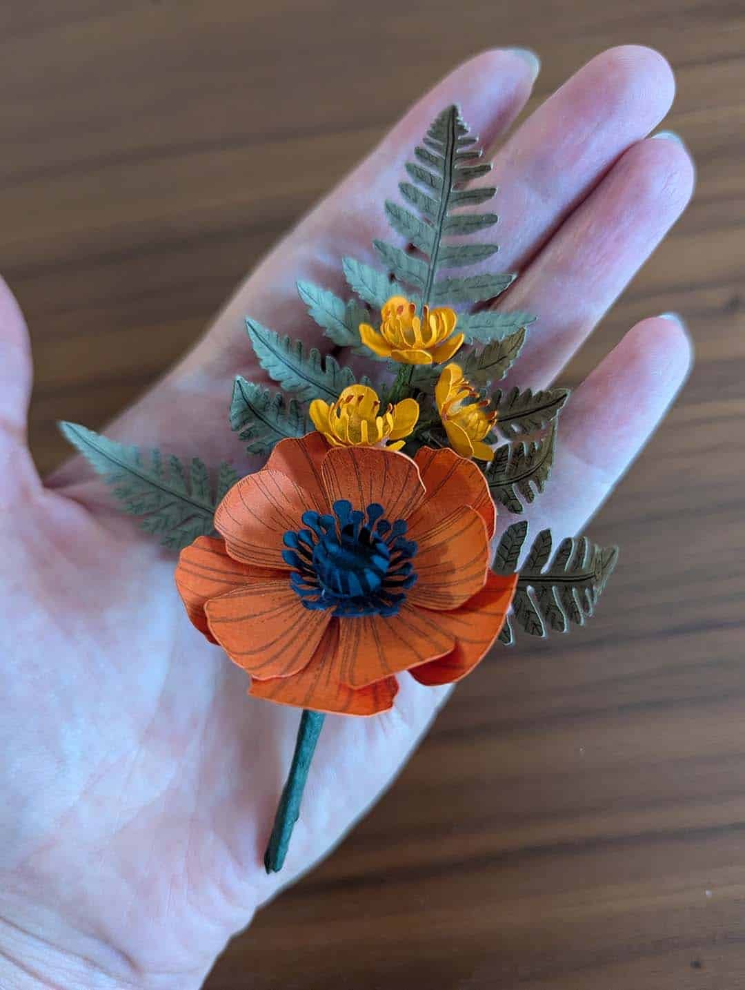 Boutonnière fleurs en papier anémone orange et wax jaune soleil pour mariage